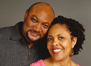 Couple looking at the camera and smiling.